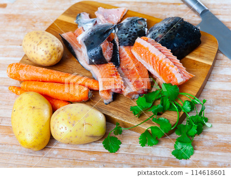 Salmon offal served with vegetables on board 114618601
