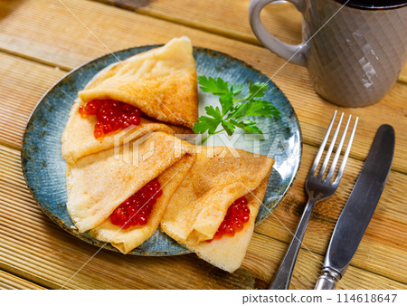 Tasty russian pancakes with red caviar at plate closeup 114618647