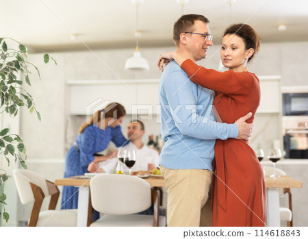 Men and women of different nationalities having fun dancing slow dance at house party 114618843