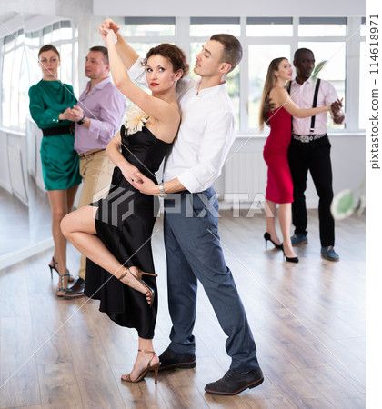 Man and woman dancing waltz in couple during lesson at studio Man and woman dancing waltz in couple during lesson at studio 114618971