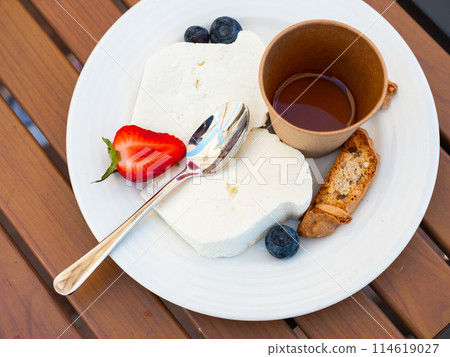 Mato cheese served with honey and berries Mato cheese served with honey and berries 114619027