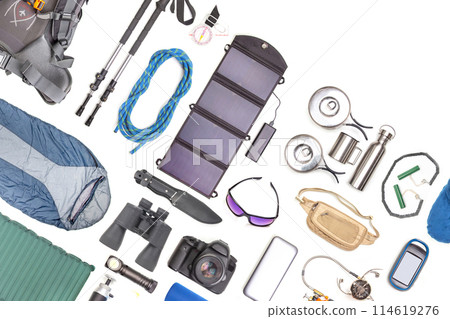 Set of tourist trekking items on white background. Top view of accessories for travel. Set of tourist trekking items on white background. Top view of accessories for travel. 114619276