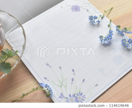Forget-me-nots and mint tea on a piece of writing paper Forget-me-nots and mint tea on a piece of writing paper 114619646