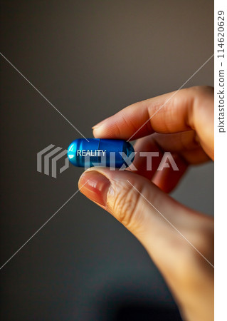 A blue pill with the word "reality" written on it 114620629