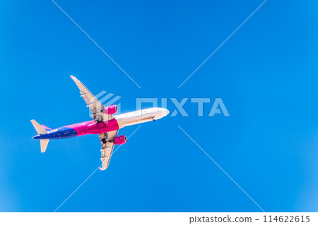Airplane before landing in blue sky, Airbus A321 114622615