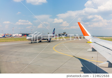 View from the airplane window during takeoff at Sheremetyevo airport at summer View from the airplane window during takeoff at Sheremetyevo airport at summer 114622688