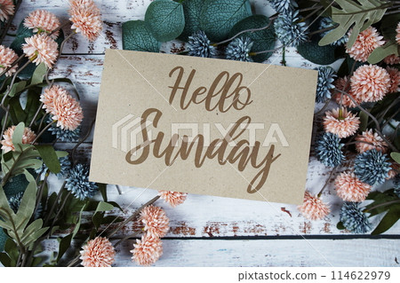 Happy Sunday text message on paper card with flowers border frame on wooden background Happy Sunday text message on paper card with flowers border frame on wooden background 114622979