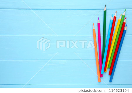 Many different colored pencils on blue wooden background Many different colored pencils on blue wooden background 114623194