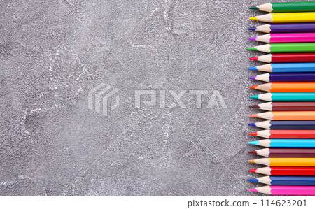 Many different colored pencils on grey concrete background Many different colored pencils on grey concrete background 114623201