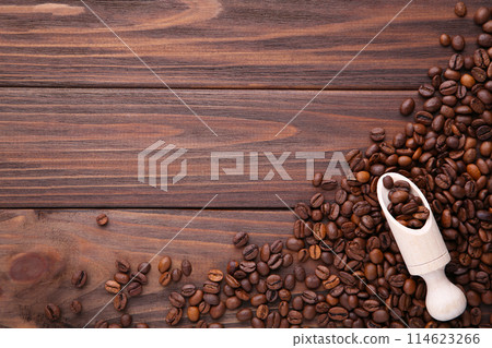 Coffee beans in wood spoon on brown background. 114623266