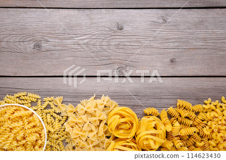 Delicious mixed pasta on a grey wooden background Delicious mixed pasta on a grey wooden background 114623430