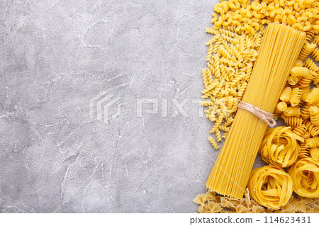 Delicious mixed pasta on a grey concrete background, frame 114623431