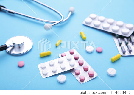 Stethoscope with pills on blue background. Top view with place for your text. 114623462