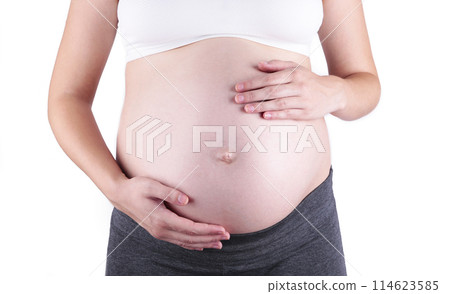 A cute pregnant belly isolated on a white background A cute pregnant belly isolated on a white background 114623585