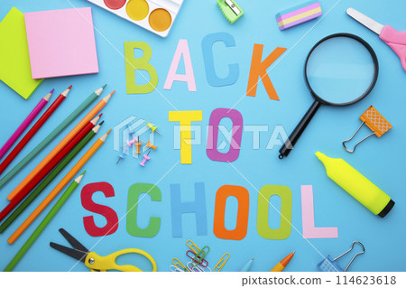 Inscription Back To School with school supplies on blue background Inscription Back To School with school supplies on blue background 114623618