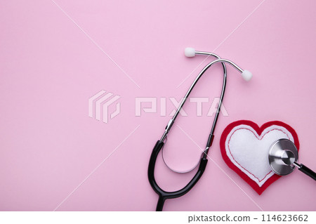 Stethoscope and heart on a pink background. Health, medicine Stethoscope and heart on a pink background. Health, medicine 114623662