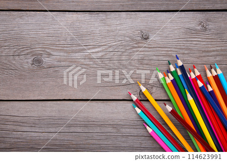 Many different colored pencils on grey wooden background Many different colored pencils on grey wooden background 114623991