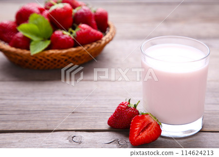 Yogurt with strawberry in glass on grey wooden background Yogurt with strawberry in glass on grey wooden background 114624213