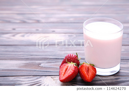 Yogurt with strawberry in glass on brown wooden background Yogurt with strawberry in glass on brown wooden background 114624270