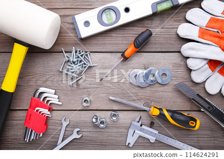 Construction tools on a grey wooden desk. 114624291
