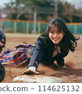 A student in uniform sliding into home base 114625132