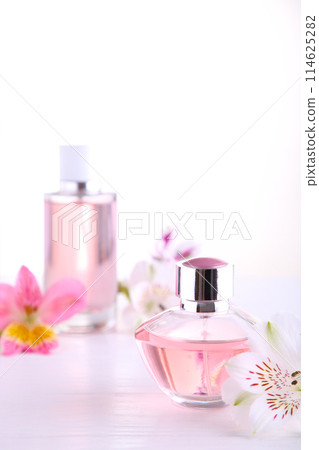 Perfume bottles with flowers on white background, top view 114625282