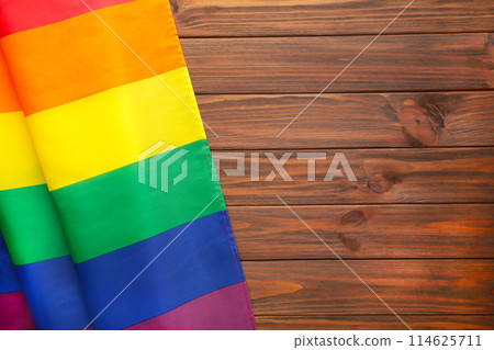 Rainbow LGBT flag on brown wooden background with copy space Rainbow LGBT flag on brown wooden background with copy space 114625711