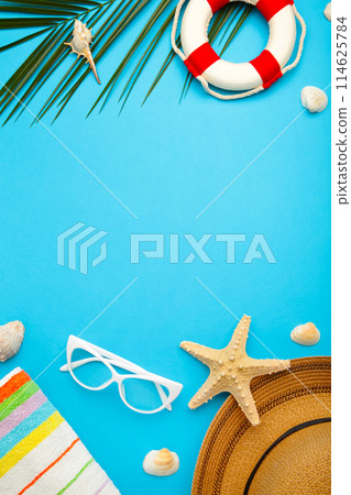 Beach accessories with palm leaves on blue background 114625784