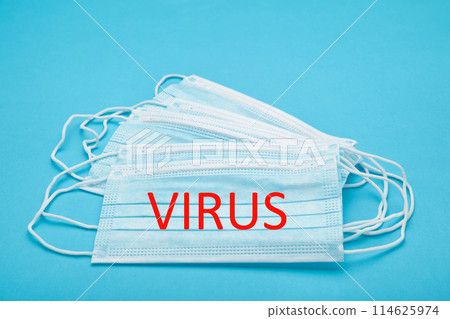 Medical masks on a blue background with copy space. The inscription Virus Medical masks on a blue background with copy space. The inscription Virus 114625974