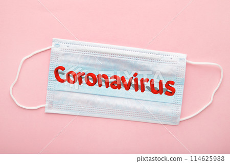 Medical masks on a pink background with copy space. The inscription Coronavirus Medical masks on a pink background with copy space. The inscription Coronavirus 114625988
