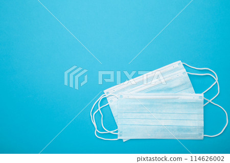 Medical masks on a blue background with copy space. Coronavirus Medical masks on a blue background with copy space. Coronavirus 114626002
