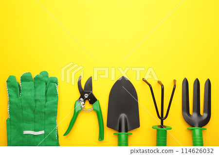 Gardening tools on yellow background, top view 114626032