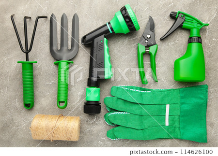 Gardening tools on grey concrete background, top view Gardening tools on grey concrete background, top view 114626100