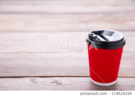 Red paper cup of coffee on grey wooden background 114626286