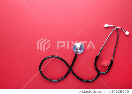 Medical stethoscope on red background. Health care concept Medical stethoscope on red background. Health care concept 114626300