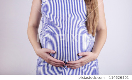 A cute pregnant belly on grey background 114626301