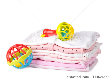 Baby clothes with rattle isolated on white background Baby clothes with rattle isolated on white background 114626332