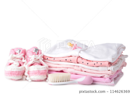 Baby clothes with booties and comb isolated on white background Baby clothes with booties and comb isolated on white background 114626369