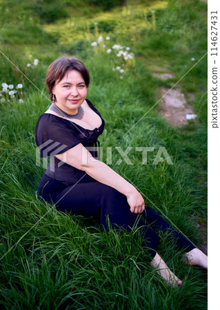 a medium size woman in a black corset and wide leg trousers walks through the city in the morning light a medium size woman in a black corset and wide leg trousers walks through the city in the morning light 114627431