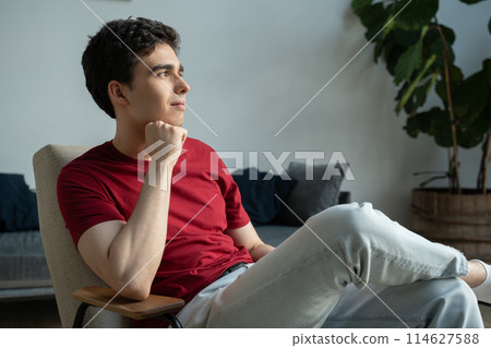 Young Man In Casual Attire Deep In Thought At Home During Daytime Young Man In Casual Attire Deep In Thought At Home During Daytime 114627588