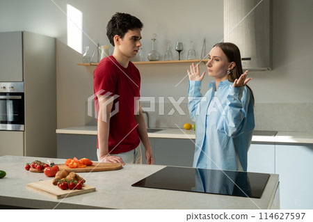 Young Couple Arguing in Modern Kitchen During Dinner Preparation at Evening 114627597