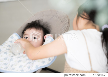 Older sister taking care of baby Older sister taking care of baby 114628467