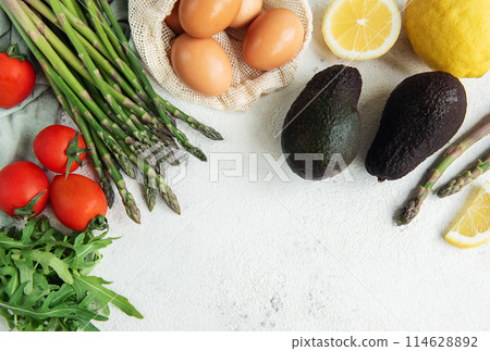 Fresh Vegetables and Eggs Arranged on a Light Surface for Healthy Cooking Fresh Vegetables and Eggs Arranged on a Light Surface for Healthy Cooking 114628892