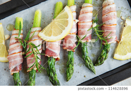 Asparagus with ham before baking Asparagus with ham before baking 114628896