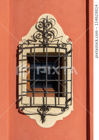 ornate window grill on colorful wall 114629814