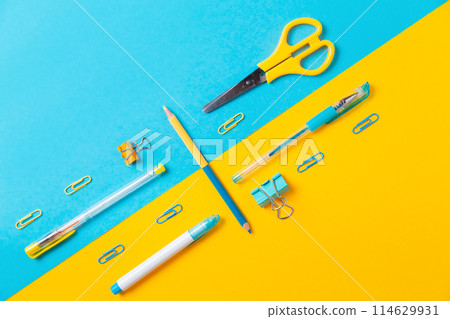 Blue and yellow office supplies on background. Flat lay. Back to school. Education and bussines concept 114629931
