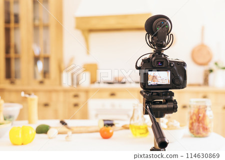 Stylish kitchen with minimalist interior. Professional camera takes photo of blurred kitchen in daylight. food blog 114630869