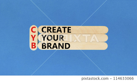 CYB Create your brand symbol. Concept words CYB Create your brand on beautiful wooden stick. Beautiful blue background. Business CYB Create your brand concept. Copy space. 114633066