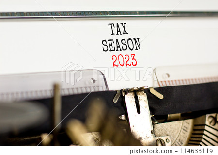 Tax season 2023 symbol. Concept words Tax season 2023 typed on an old retro typewriter on a beautiful white paper background. Business Tax season 2023 concept. Copy space. 114633119
