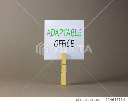 Adaptable office symbol. Concept words Adaptable office on beautiful white paper on wooden clothespin. Beautiful grey background. Business Adaptable office concept. Copy space. 114633134